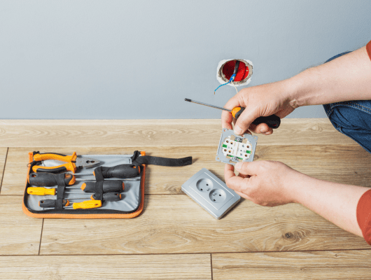 man installs electrical outlet gray wall 1 min 1