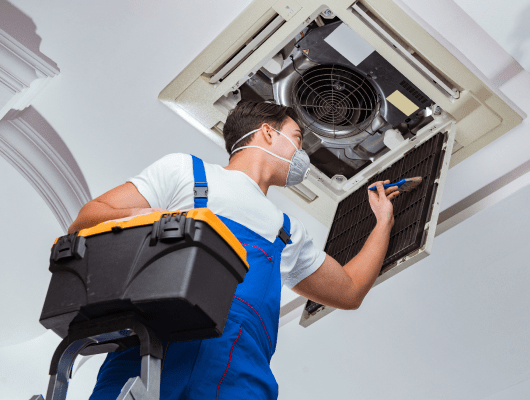 worker repairing ceiling air conditioning unit 1 min 1
